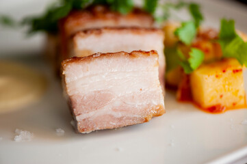 Pork belly. Pork seasoned with cracked black pepper and served with classic steakhouse side dishes: asparagus and mashed potatoes. Classic Japanese izakaya fine dining entree.