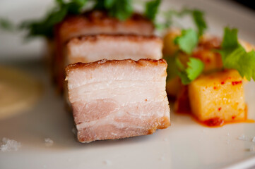 Pork belly. Pork seasoned with cracked black pepper and served with classic steakhouse side dishes: asparagus and mashed potatoes. Classic Japanese izakaya fine dining entree.