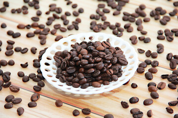 natural black coffee beans in a decorative plate