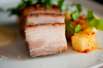 Pork belly. Pork seasoned with cracked black pepper and served with classic steakhouse side dishes: asparagus and mashed potatoes. Classic Japanese izakaya fine dining entree.