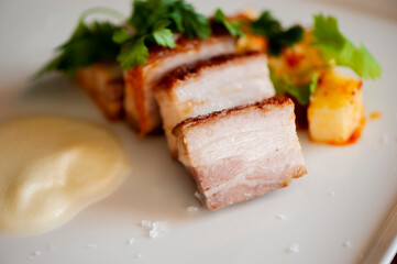 Pork belly. Pork seasoned with cracked black pepper and served with classic steakhouse side dishes: asparagus and mashed potatoes. Classic Japanese izakaya fine dining entree.