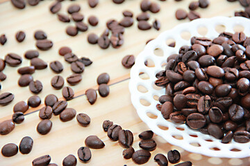 natural black coffee beans in a decorative plate