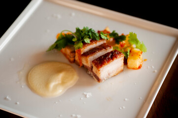 Pork belly. Pork seasoned with cracked black pepper and served with classic steakhouse side dishes: asparagus and mashed potatoes. Classic Japanese izakaya fine dining entree.