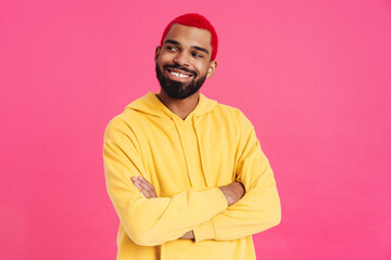 Joyful african american guy posing with arms crossed