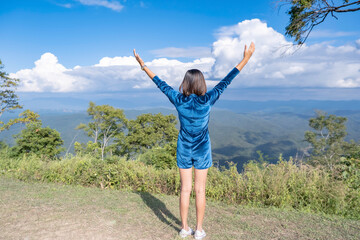 Fototapeta premium The image behind the women raise their arms looked at the mountains and cloud at Doi Samer Dao , Nan in Thailand
