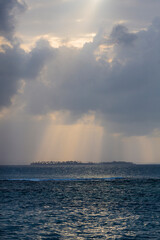Naklejka premium Dramatic sunset on a remote paradisiac island