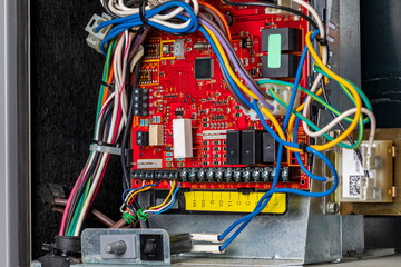 Closeup of heater circuit control board inside of furnace. Concept of HVAC maintenance, repair, service and installation