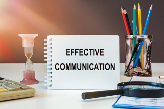 Effective Communication is written on a notepad on an office desk