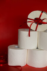 covid-19 toilet roll christmas tree with red christmas ribbon on red background 