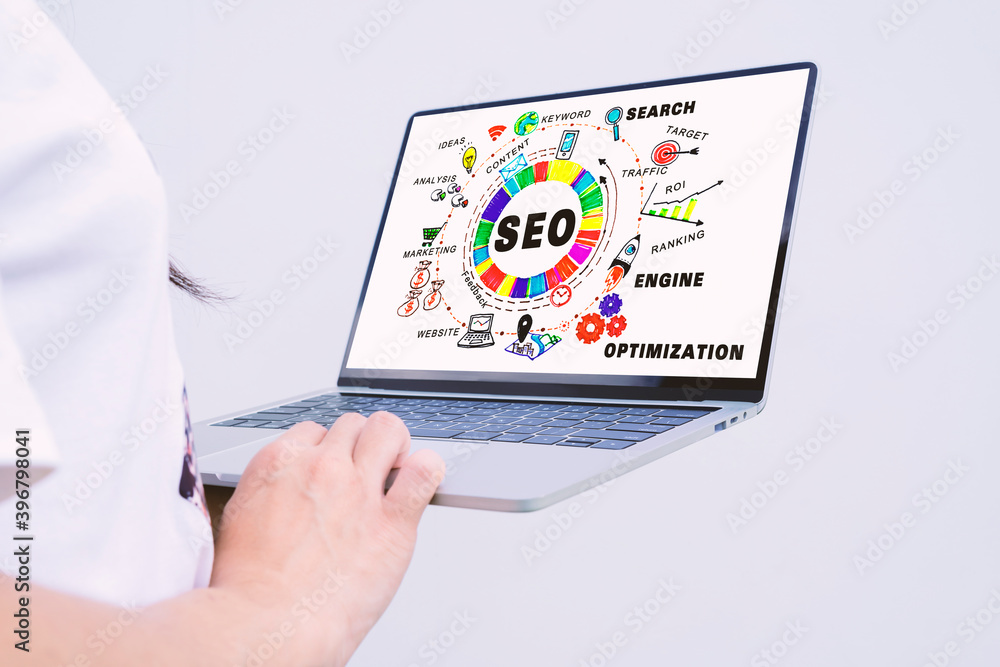 Poster searching engine optimizing seo browsing concept. close-up of a business woman's hand using a laptop