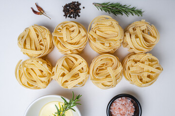 flat lay pasta, tagliatelle, with rosemary, pepper corns, sea salt, dry dried chillies and olive oil