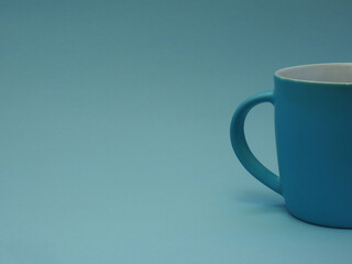 Simple blue cup without label on blue background