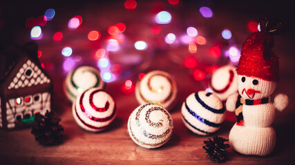 Christmas balls and a toy snowman on Christmas table