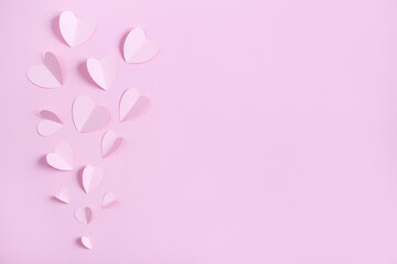 .top view of paper hearts on pink background