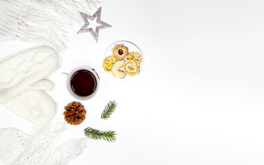 Festive Christmas composition. Scarf, Plaid, Cup of coffee, tea, fir tree branches and Xmas cookies on white background. Christmas, winter, new year concept. Flat lay, top view. Copy space for text