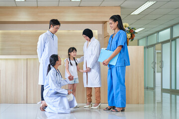 Kid girl patient in group of Doctors in lobby hospital healthcare service