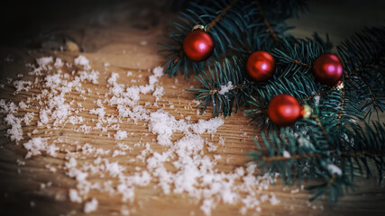 Fototapeta na wymiar Christmas background.Christmas tree branch with balls on wooden