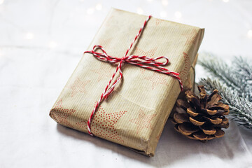 Gift box packed in paper and tied with twine, christmas zero waste, eco-friendly DIY gift wrapping