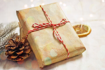 Gift box packed in paper and tied with twine, christmas zero waste, eco-friendly DIY gift wrapping