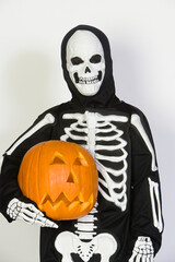 Boy In Skeleton Outfit Holding A Pumpkin