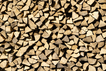 stacked wood on a house wall in summer