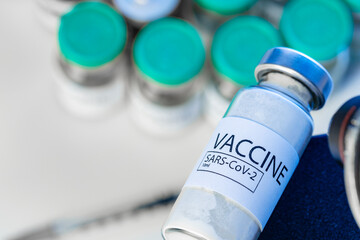 Covid-19 vaccine bottle with a syringe on lab table