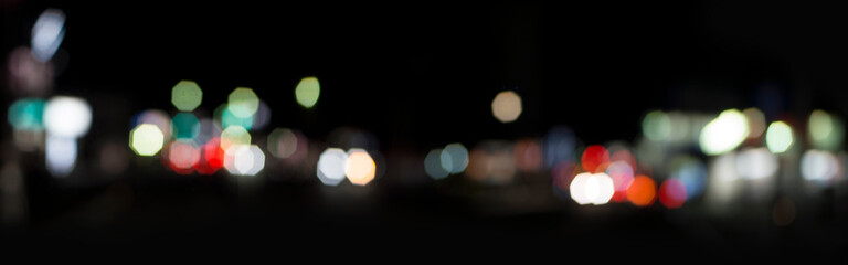 Bokeh of colorful city lights. Lights of shops, bars and restaurants at night. Unfocused camera...