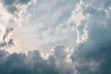 Fototapeta na wymiar blue sky with white fluffy clouds and sun rays