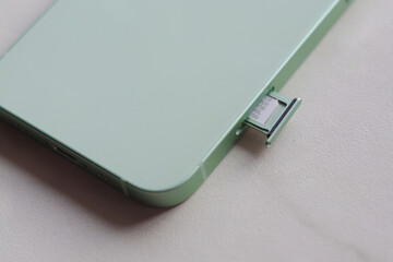 SIM card slot sticking out the green phone