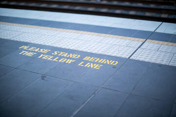 stand behind the yellow line