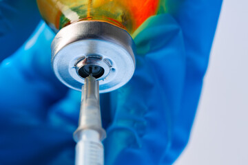Doctor hands holding glass vial with medication
