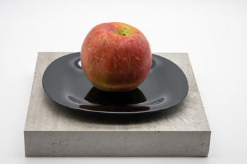 big red apple lying on a plate