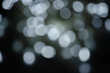 Abstract pattern of bokeh garland lights on a dark background