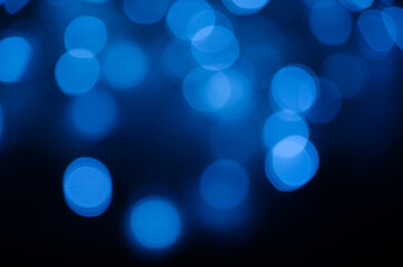 Abstract pattern of blue bokeh lights on black background