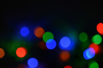 Abstract pattern of colorful bokeh lights on a dark background