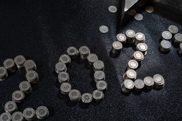 High angle view of New Years 2021 as Swiss coins on a black background.