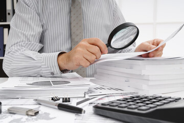business concept - businessman's working table close view, checks financial reports, writes and counts