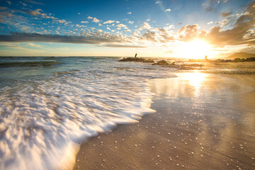 Wide angle view of a wave washing up on the beach on the Gruis beach in Gansbaai South Africa