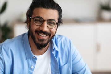 Closeup Portrait Of Positive Indian Guy With Dental Braces And Eyeglasses