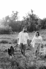 American Akita dog for a walk with a guy and a girl
