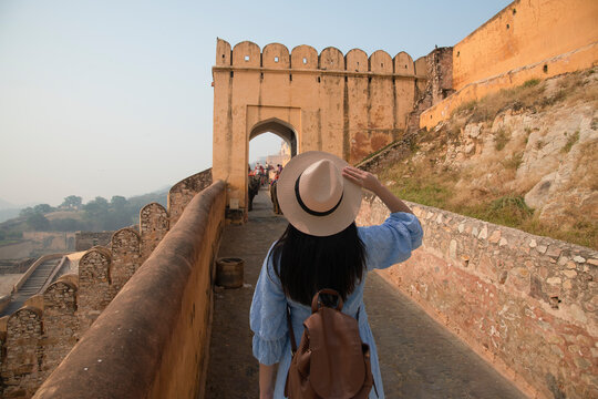Woman tourist is sightseeing at Amber Fort Jaipur Rajasthan