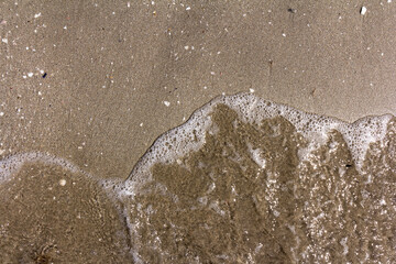 The background of sand with water splash into summer with space for text.