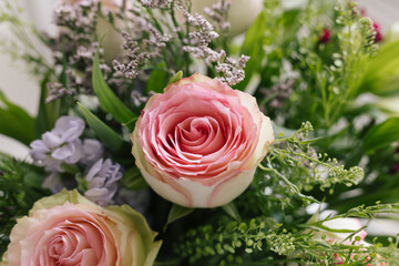 tight angled view of bouquet of rose flowers bunch pink green purple macro close up horizontal focussed