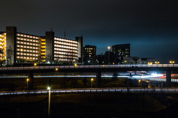 Stockholm, Sweden Apartment buildings and highway in the  Rinkeby suburb at  night.