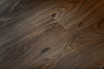 Fototapeta premium The surface of the brown parquet board. Background. Space for text.