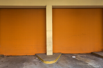 Two orange closed garage doors on side of large building in downtown Atlanta Georgia