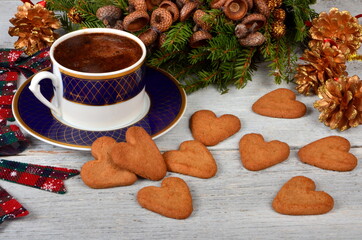 Coffee cup with gingerbread cookies on table and Christmas decorations