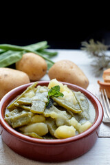 Pods with potatoes in clay pot