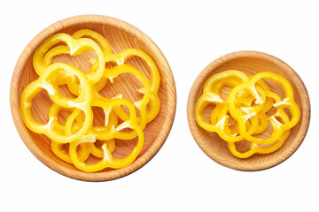 Sliced yellow bell pepper in a wooden bowl isolated on white background.  Top view.