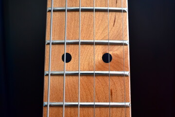 Electric guitar background. Maple fretboard and strings close-up.
